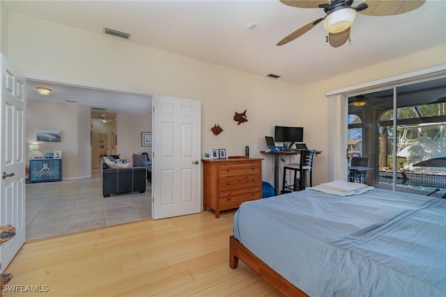 bedroom featuring ceiling fan, light hardwood / wood-style flooring, and access to outside