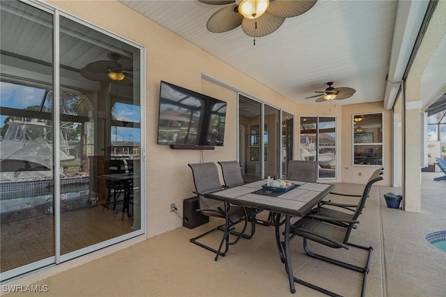 sunroom featuring ceiling fan