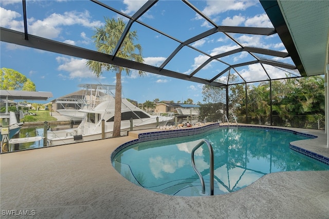 view of pool featuring a patio area and glass enclosure