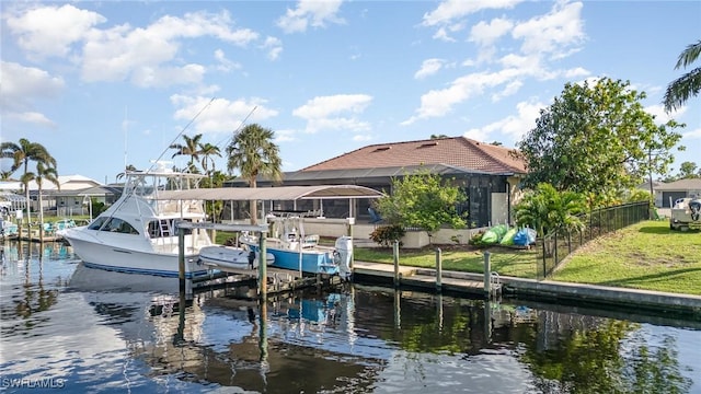 dock area featuring a water view, a lawn, and glass enclosure