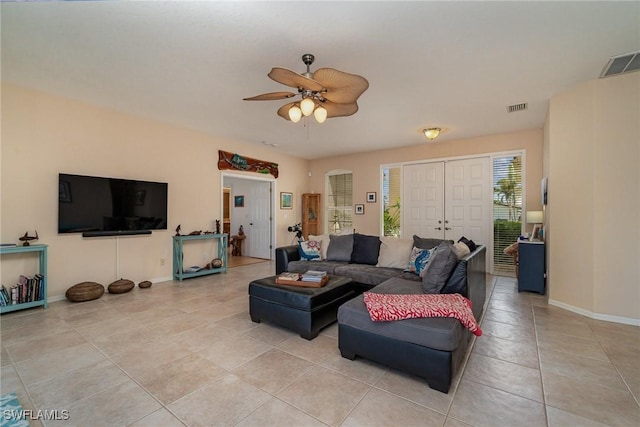 living room with ceiling fan and light tile patterned flooring