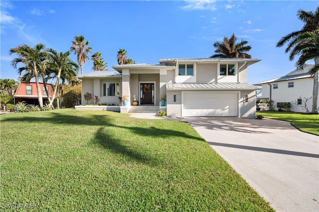 view of front of property with a garage and a front lawn