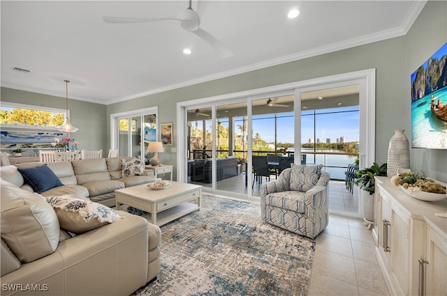 living room featuring plenty of natural light, crown molding, and light tile patterned flooring