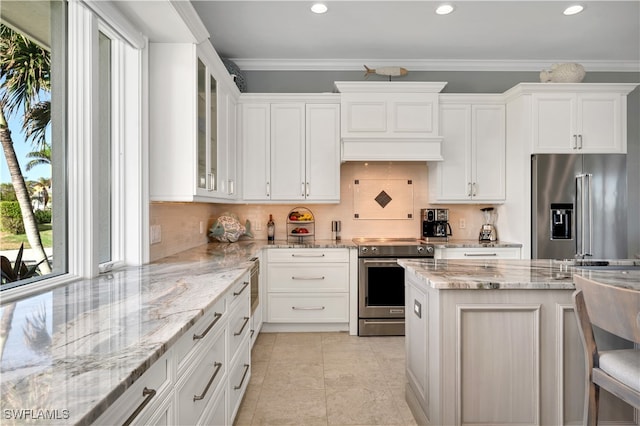 kitchen featuring backsplash, stainless steel appliances, light stone counters, and crown molding