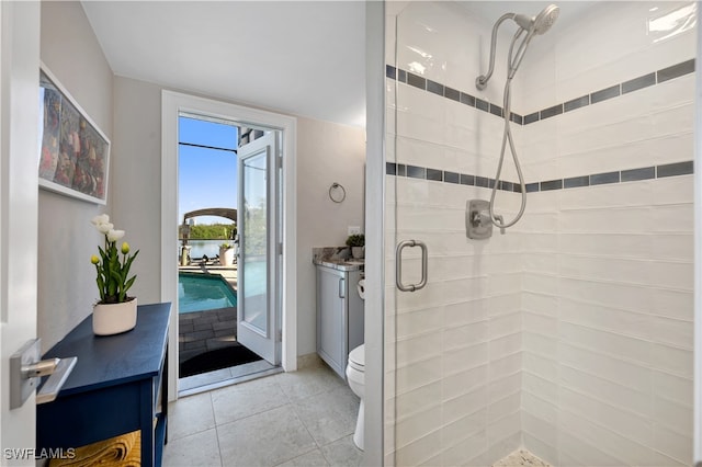 bathroom with tile patterned floors, toilet, vanity, and walk in shower