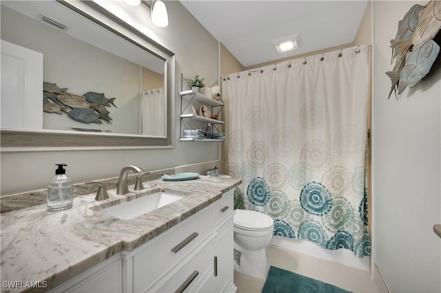 bathroom with tile patterned floors, vanity, and toilet