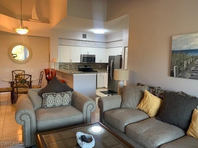 living room featuring visible vents and light tile patterned flooring