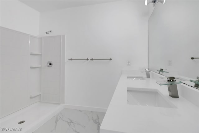 bathroom with tiled shower and vanity