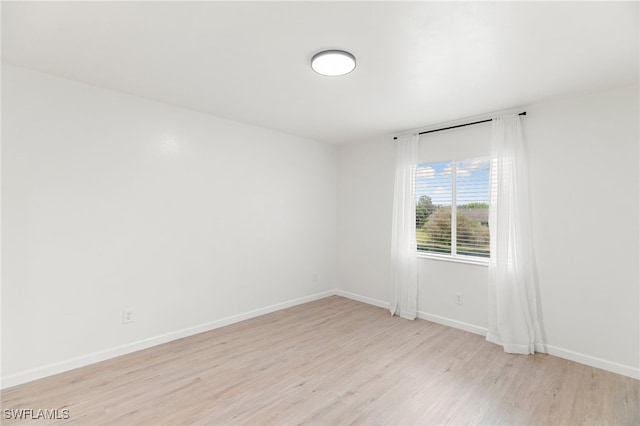 empty room with light hardwood / wood-style flooring