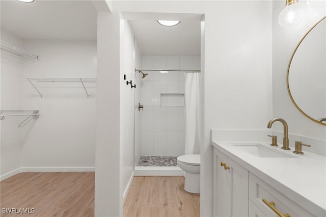 bathroom with curtained shower, wood-type flooring, toilet, and vanity