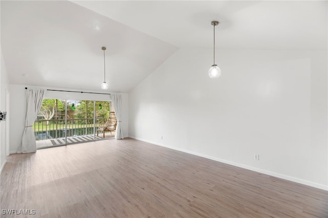 unfurnished living room featuring hardwood / wood-style flooring and lofted ceiling