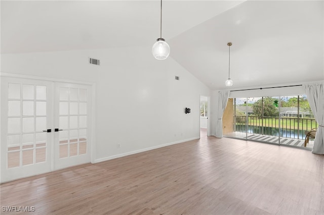 unfurnished living room featuring light hardwood / wood-style floors and high vaulted ceiling