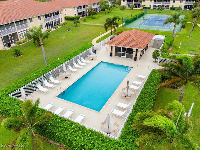 view of swimming pool with tennis court