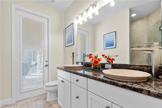 bathroom featuring toilet, an enclosed shower, and vanity