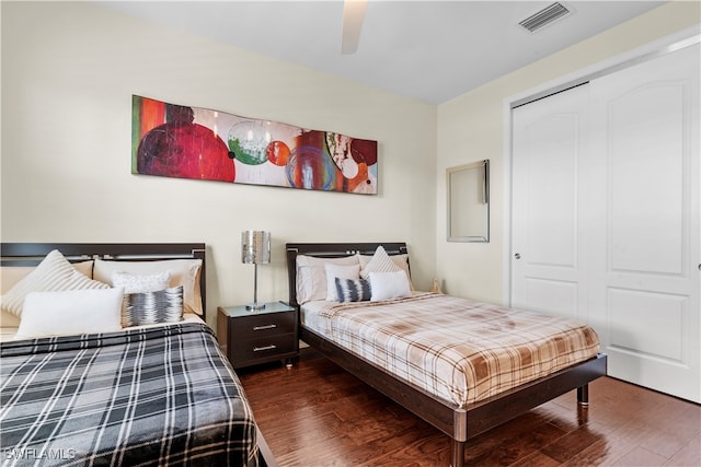 bedroom featuring ceiling fan, a closet, and dark hardwood / wood-style floors