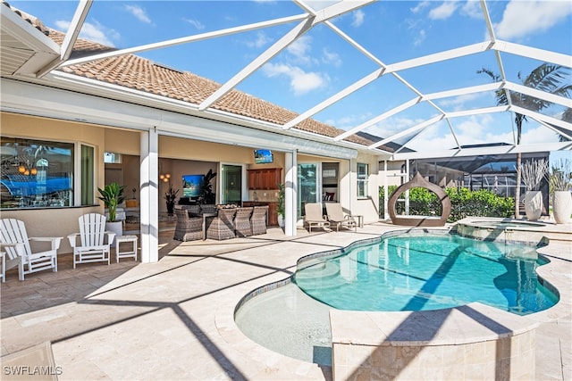 view of swimming pool with a lanai, a patio area, and an in ground hot tub