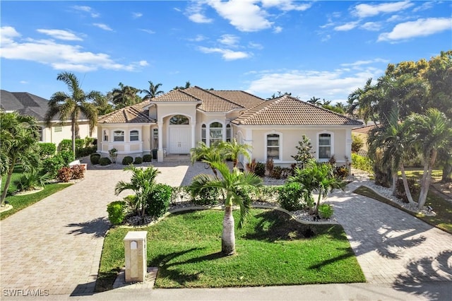 mediterranean / spanish-style house featuring a front lawn