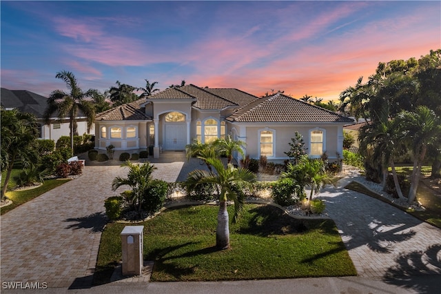 mediterranean / spanish-style house featuring a yard