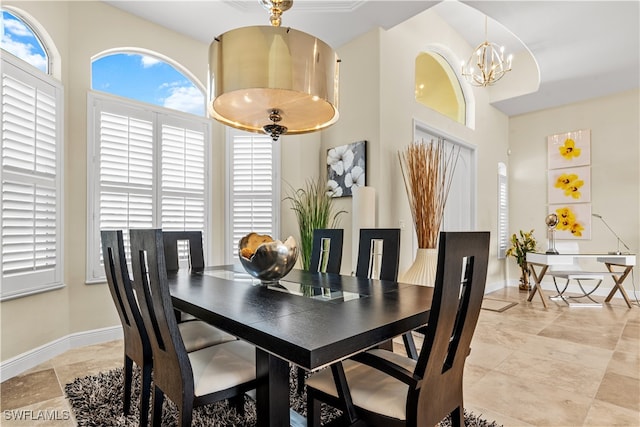 dining room featuring an inviting chandelier and a high ceiling