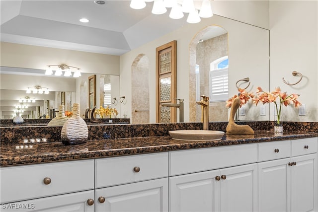 bathroom featuring lofted ceiling and vanity