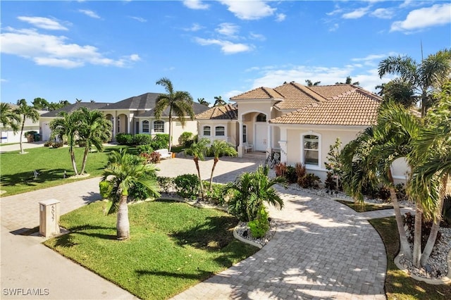 mediterranean / spanish-style house featuring a front lawn