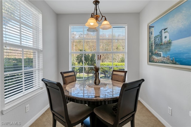 dining space featuring a chandelier and light tile patterned floors