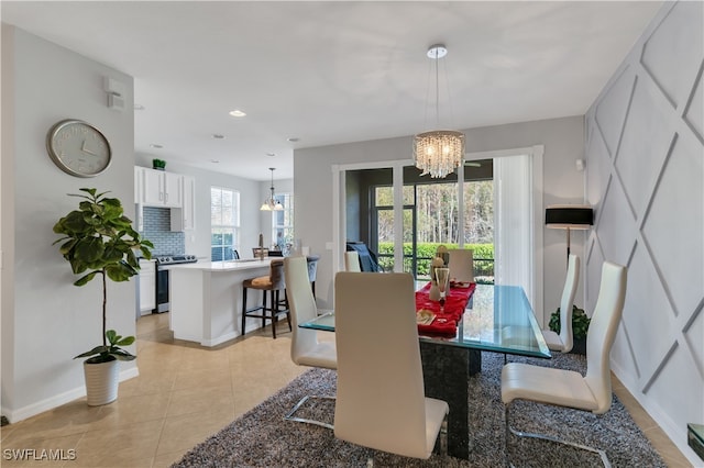 tiled dining area featuring a chandelier