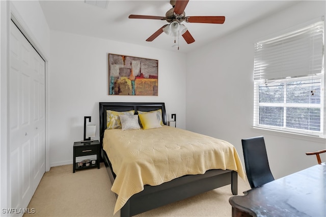 carpeted bedroom with a closet and ceiling fan