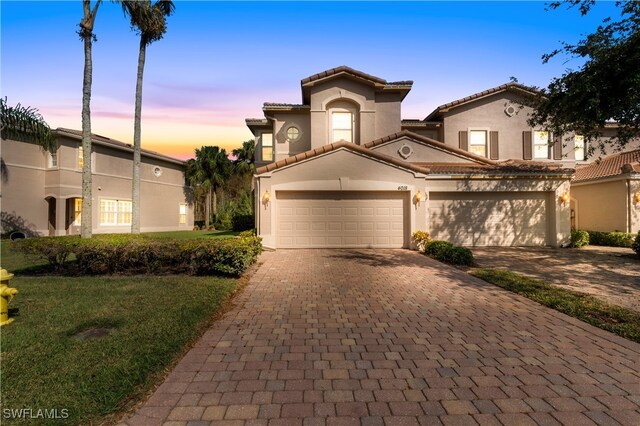 mediterranean / spanish-style house with a garage