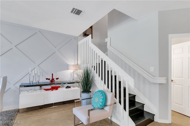 stairway with tile patterned flooring