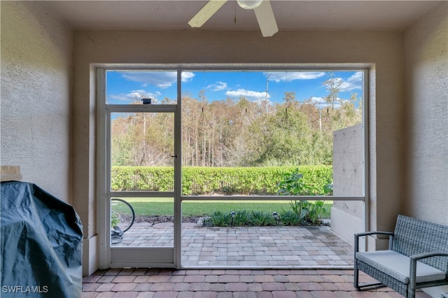 sunroom featuring ceiling fan