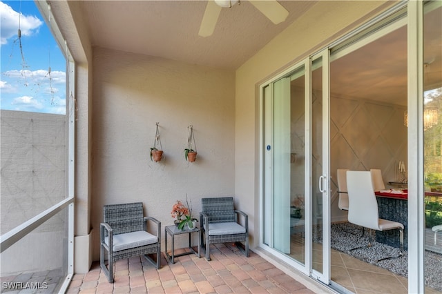 sunroom / solarium featuring ceiling fan