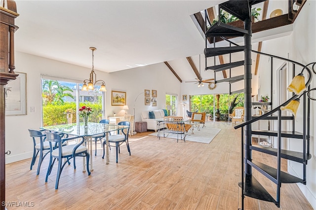 dining room with ceiling fan with notable chandelier, vaulted ceiling with beams, and light wood-type flooring