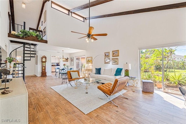 6440 Royal Woods Dr, Fort Myers, FL 33908 - living room featuring high vaulted ceiling, a ceiling fan, stairs, light wood-type flooring, and beamed ceiling
