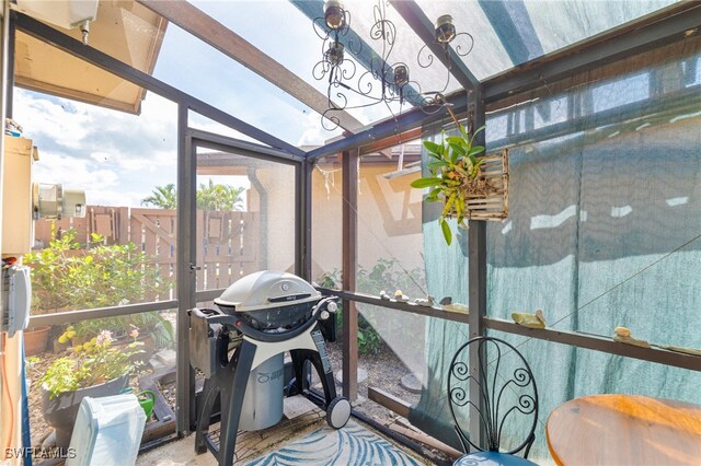 sunroom / solarium featuring vaulted ceiling