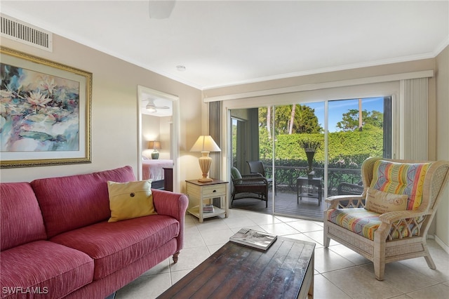 living room featuring ceiling fan, light tile patterned floors, and ornamental molding