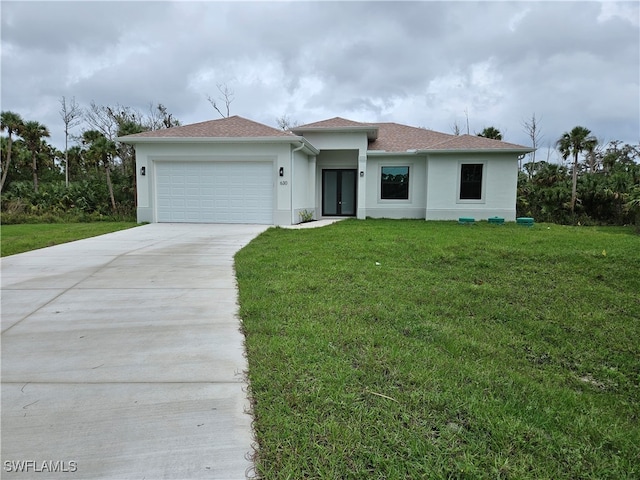 view of front of house with a front lawn and a garage