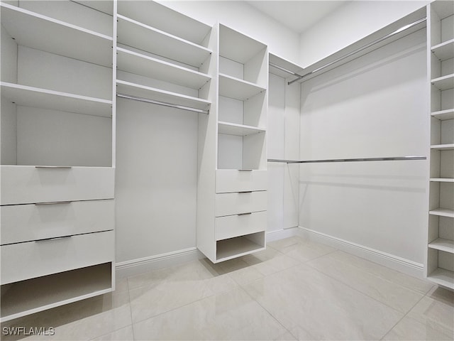 spacious closet with light tile patterned floors