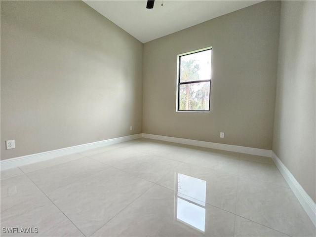 empty room featuring light tile patterned flooring and ceiling fan