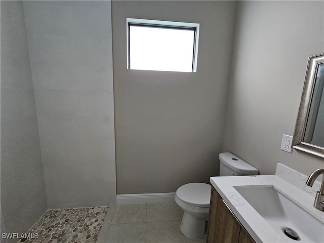 bathroom featuring vanity, tile patterned flooring, and toilet