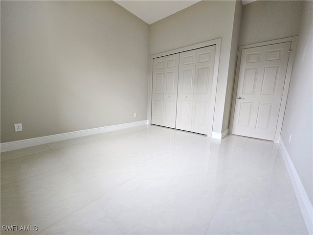 unfurnished bedroom featuring light tile patterned floors and a closet