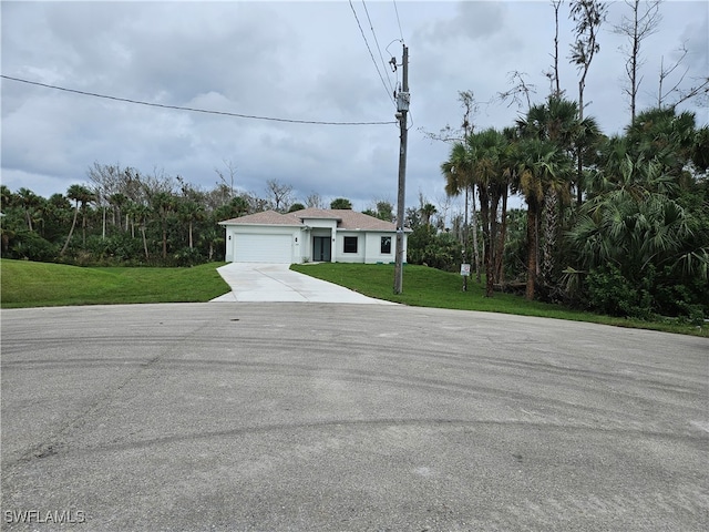 view of front of house with a front lawn and a garage