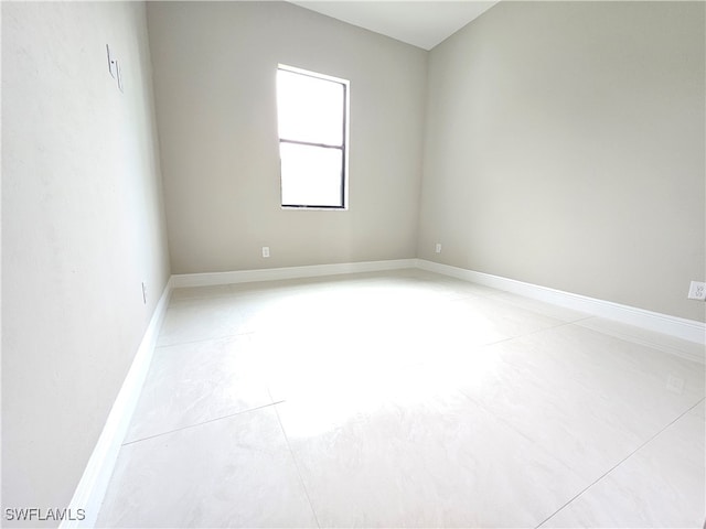 empty room with light tile patterned floors