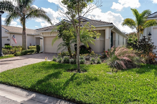 view of front of house featuring a garage and a front lawn