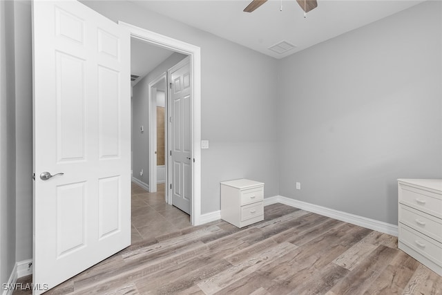 unfurnished bedroom with light wood-type flooring and ceiling fan