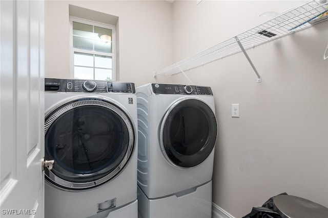 washroom with washing machine and clothes dryer