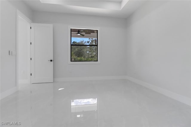 spare room with light tile patterned floors and ceiling fan