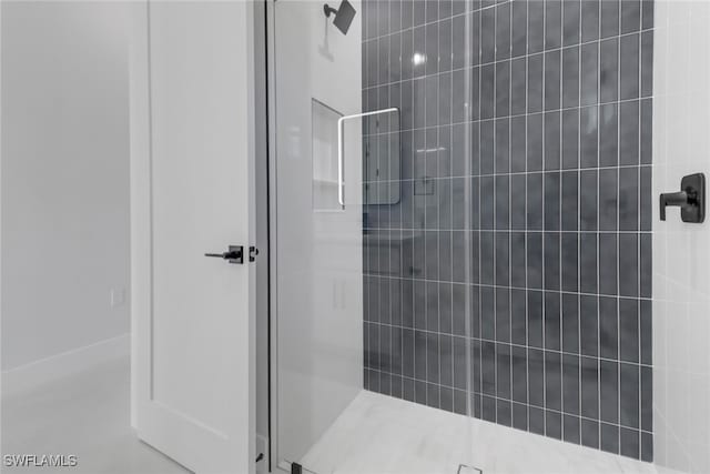 bathroom with a shower with shower door