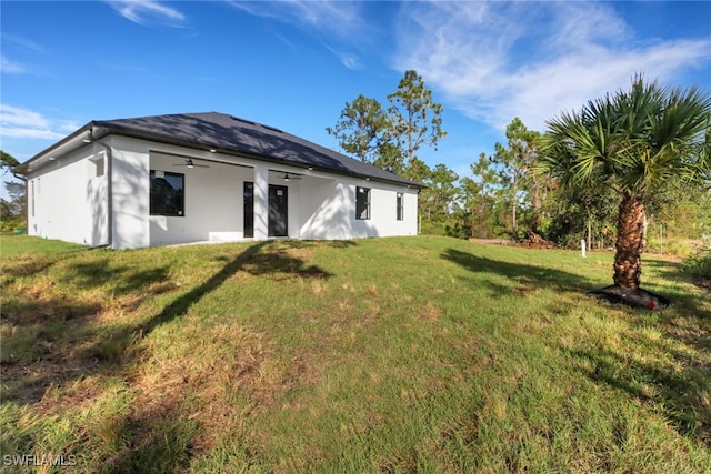 rear view of property featuring a yard