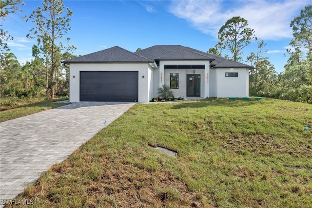 view of front of property featuring a front lawn and a garage